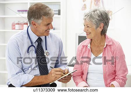 Stock Photo - Doctor with female patient. Fotosearch