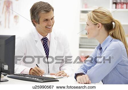 Stock Photo - Doctor with female patient. Fotosearch