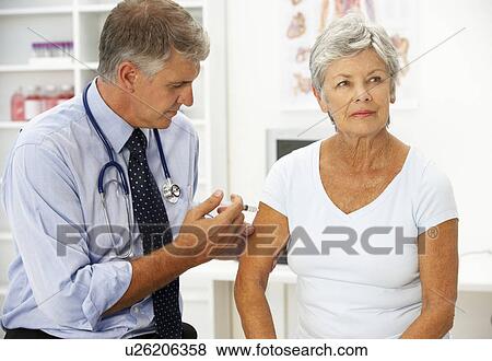Stock Photo - Doctor with female patient. Fotosearch