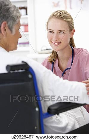 Stock Photo - Doctor with female patient. Fotosearch