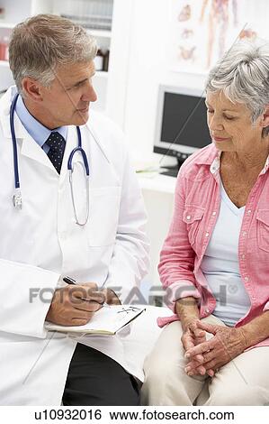 Stock Photograph - Doctor with female patient. Fotosearch