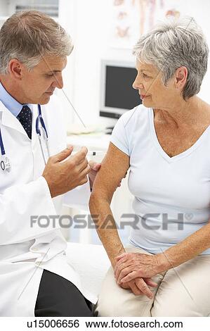 Stock Photograph - Doctor with female patient. Fotosearch