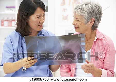 Doctor with female patient View Large Photo Image Stock Photograph - Doctor with female patient. Fotosearch