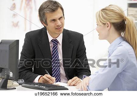 Doctor with female patient View Large Photo Image Stock Photograph - Doctor with female patient. Fotosearch