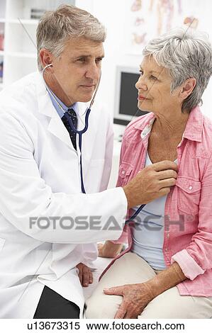 Stock Photography - Doctor with female patient. Fotosearch