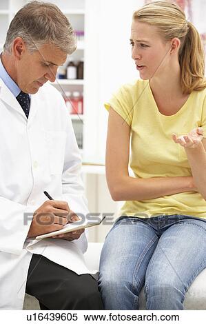 Stock Photography - Doctor with female patient. Fotosearch