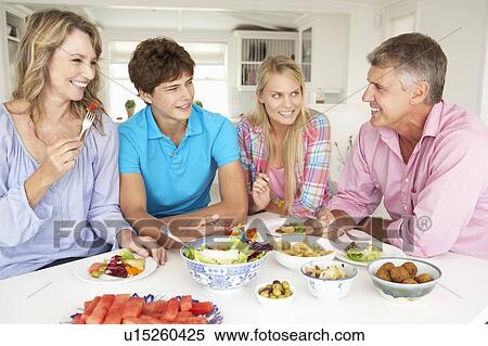 Family enjoying meal at home View Large Photo Image Stock Photography - Family enjoying meal at home. Fotosearch