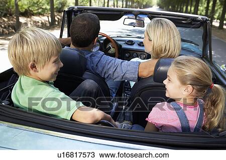Stock Image - family in sports car. Fotosearch