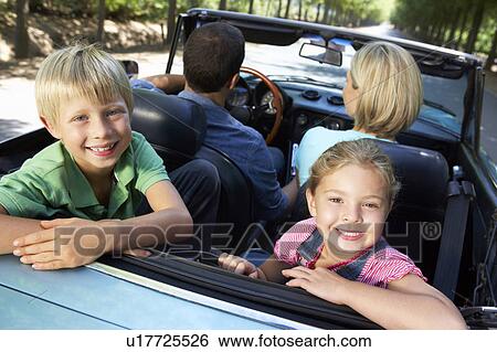 Stock Photograph - family in sports car. Fotosearch
