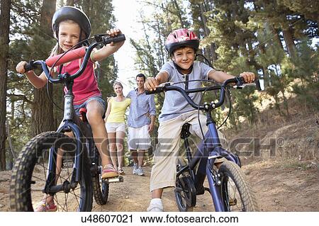 Family on country walk with bikes View Large Photo Image Stock Image - Family on country walk with bikes. Fotosearch