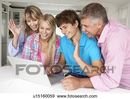 Stock Photo - Family using laptop. Fotosearch