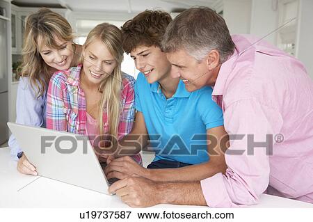 Stock Photo - Family using laptop. Fotosearch