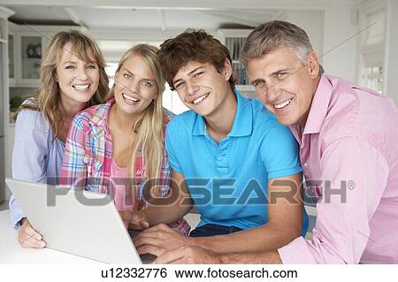 Stock Photograph - Family using laptop. Fotosearch