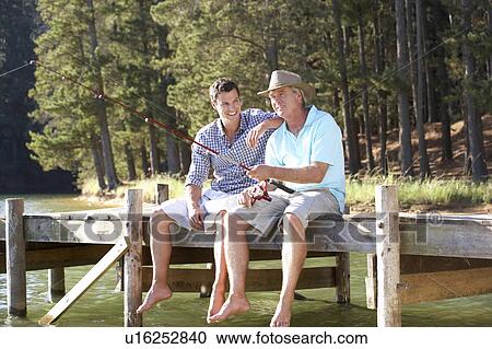 Father and adult son fishing together View Large Photo Image Stock Image - Father and adult son fishing together. Fotosearch