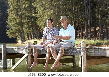 Stock Image - Father and adult son fishing together. Fotosearch
