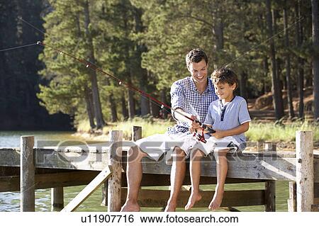 Father and son fishing together View Large Photo Image Stock Photograph - Father and son fishing together. Fotosearch
