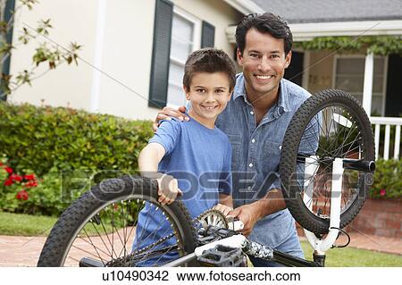 Father and son fixing bike View Large Photo Image Stock Image - Father and son fixing bike. Fotosearch