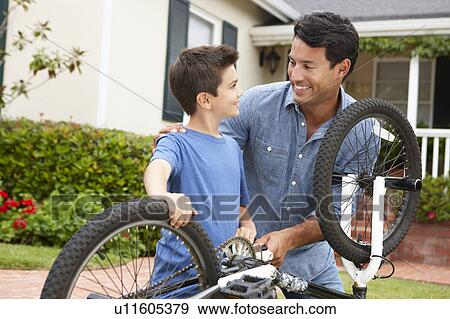 Father and son fixing bike View Large Photo Image Stock Photo - Father and son fixing bike. Fotosearch