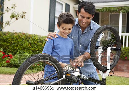 Father and son fixing bike View Large Photo Image Stock Photography - Father and son fixing bike. Fotosearch