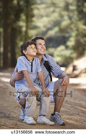 Father and son on country walk View Large Photo Image Stock Photograph - Father and son on country walk. Fotosearch
