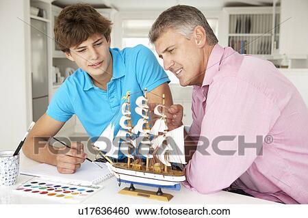 Father and teenage son model making and painting View Large Photo Image Stock Image - Father and teenage son model making and painting. Fotosearch