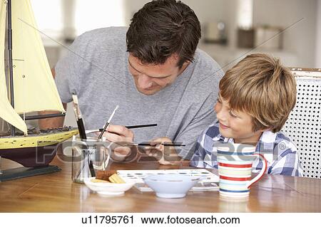 Stock Image - Father model making with son. Fotosearch