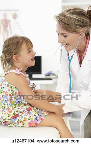 Picture - Female doctor examining child. Fotosearch
