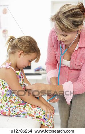Picture - Female doctor examining child. Fotosearch