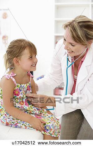 Stock Image - Female doctor examining child. Fotosearch