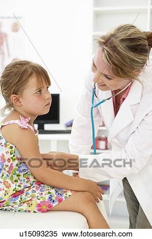 Stock Photography - Female doctor examining child. Fotosearch