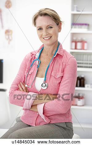 Picture - Female doctor in consulting room. Fotosearch