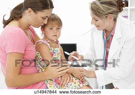 Picture - Female doctor injecting child. Fotosearch
