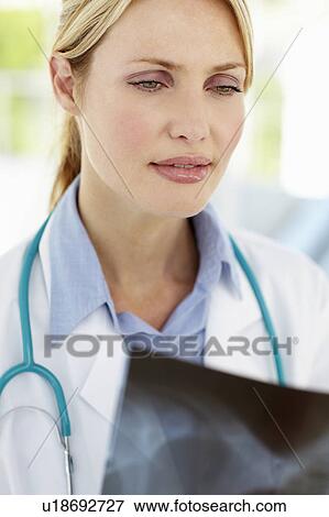 Female doctor with x-ray View Large Photo Image Stock Photo - Female doctor with x-ray. Fotosearch