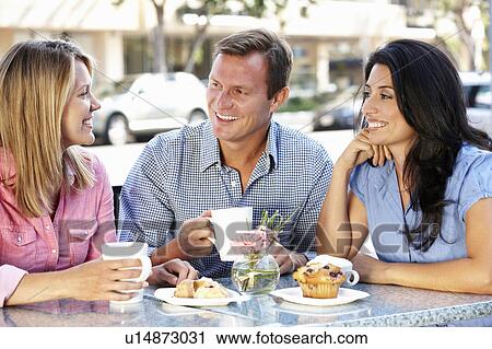 Friends chatting outside café View Large Photo Image Stock Image - Friends chatting outside café. Fotosearch