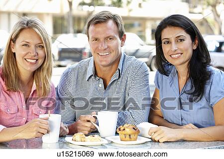 Friends chatting outside café View Large Photo Image Stock Photo - Friends chatting outside café. Fotosearch