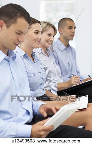 Stock Image - Group watching business presentation. Fotosearch