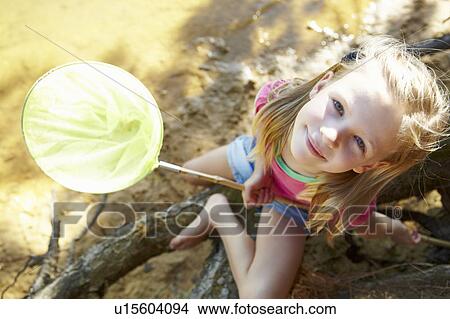 Picture - Happy girl fishing at lake. Fotosearch