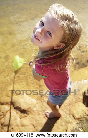 Stock Photo - Happy girl fishing. Fotosearch