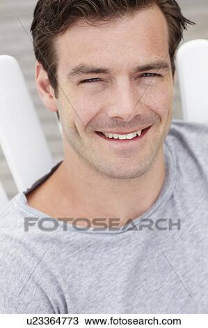 Stock Image - Head and shoulders portrait man outdoors. Fotosearch