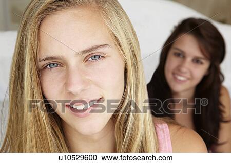 Stock Image - Head and shoulders portrait of teenage girls. Fotosearch