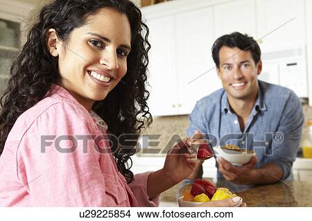 Hispanic couple eating cereal and fruit View Large Photo Image Picture - Hispanic couple eating cereal and fruit. Fotosearch