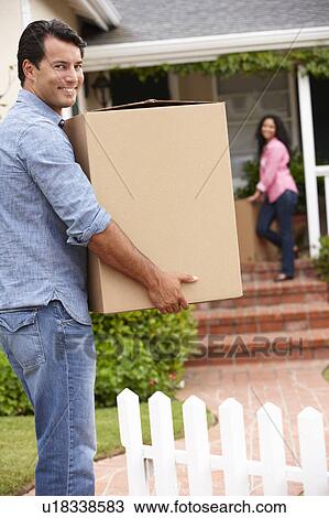 Hispanic couple moving into new house View Large Photo Image Stock Image - Hispanic couple moving into new house. Fotosearch