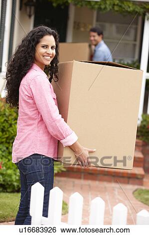 Stock Photograph - Hispanic couple moving into new house. Fotosearch