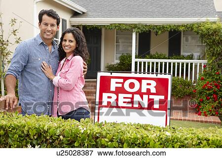 Hispanic couple outside home for rent View Large Photo Image Stock Photo - Hispanic couple outside home for rent. Fotosearch