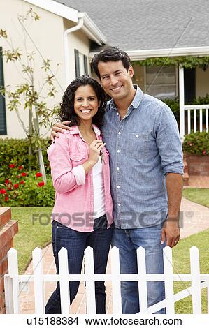 Hispanic couple outside new home View Large Photo Image Picture - Hispanic couple outside new home. Fotosearch