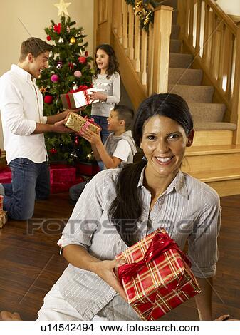 Hispanic family exchanging gifts at Christmas View Large Photo Image Picture - Hispanic family exchanging gifts at Christmas. Fotosearch