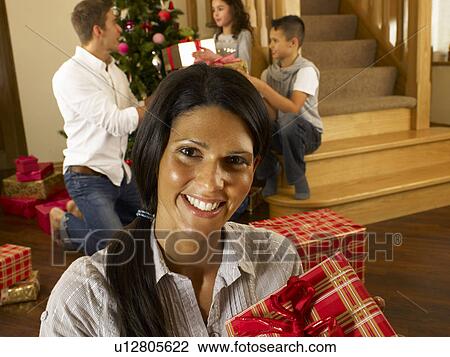 Hispanic family exchanging gifts at Christmas View Large Photo Image Stock Image - Hispanic family exchanging gifts at Christmas. Fotosearch