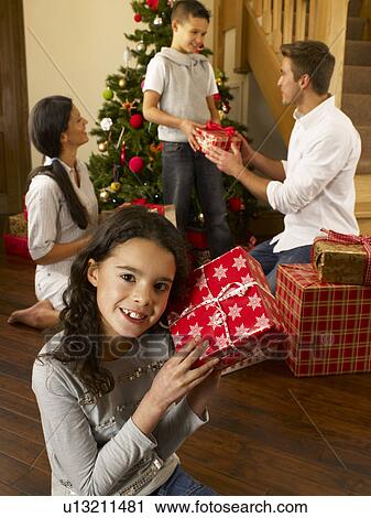 Hispanic family exchanging gifts at Christmas View Large Photo Image Stock Image - Hispanic family exchanging gifts at Christmas. Fotosearch