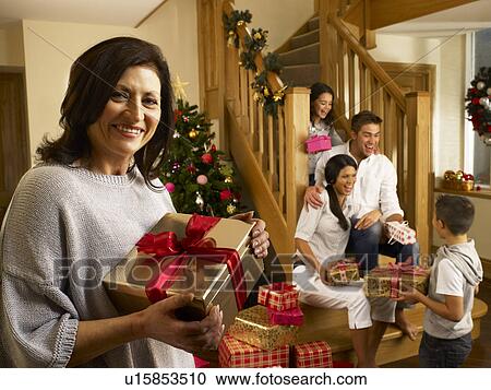 Hispanic family exchanging gifts at Christmas View Large Photo Image Stock Image - Hispanic family exchanging gifts at Christmas. Fotosearch