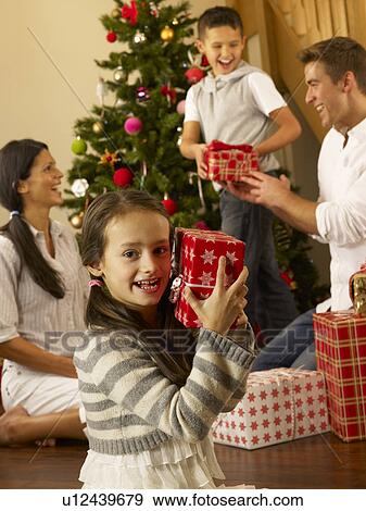 Hispanic family exchanging gifts at Christmas View Large Photo Image Stock Photo - Hispanic family exchanging gifts at Christmas. Fotosearch